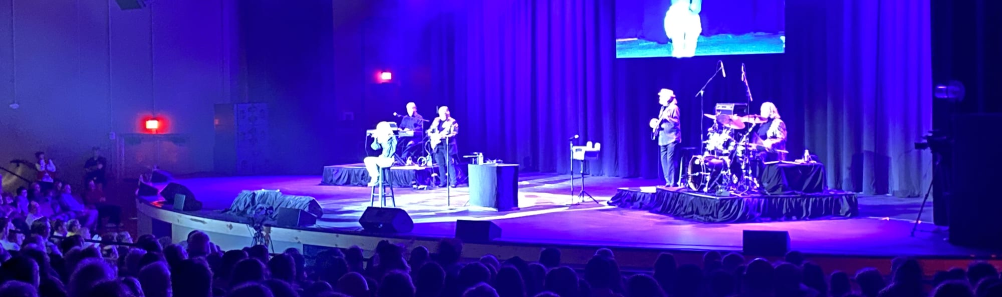 signer on stage in chair washed out by the lights Missoula